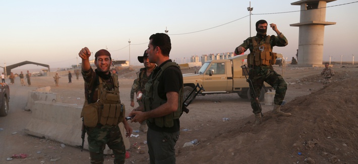 Kurdish Peshmerga fighters react during airstrikes target Islamic State militants near the Khazer checkpoint outside of Erbil, Iraq. Kurdish Peshmerga fighters react during airstrikes target Islamic State militants near the Khazer checkpoint outside of Erbil, Iraq.