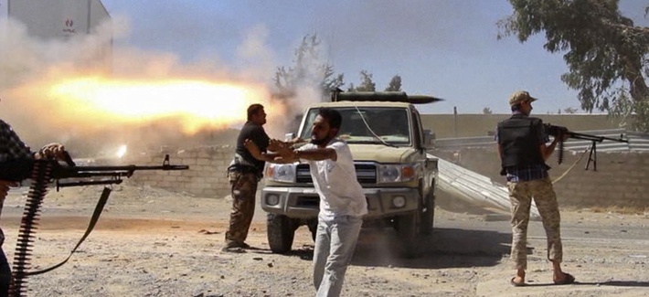 Fighters with the Misarata brigade fire towards Tripoli airport in an attempt to take control of the position from a rival militia, on July 26, 2014. Fighters with the Misarata brigade fire towards Tripoli airport in an attempt to take control of the position from a rival militia, on July 26, 2014.