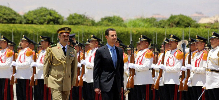 Syria's President Bashar Assad, reviews an honor guard upon his arrival at the presidential palace to take the oath of office for his new term of office, on July 16, 2014. Syria's President Bashar Assad, reviews an honor guard upon his arrival at the presidential palace to take the oath of office for his new term of office, on July 16, 2014.