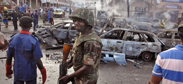 A Nigerian soldier walks at the scene of a car bomb explosion in Abuja, Nigeria, on June 25, 2014. A Nigerian soldier walks at the scene of a car bomb explosion in Abuja, Nigeria, on June 25, 2014.
