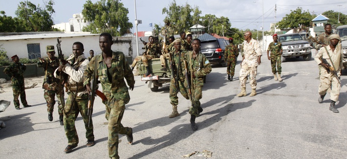 Somali soldiers patrol near the wreckage of a car bomb that detonated in Mogadishu, on July 9, 2014. Somali soldiers patrol near the wreckage of a car bomb that detonated in Mogadishu, on July 9, 2014.