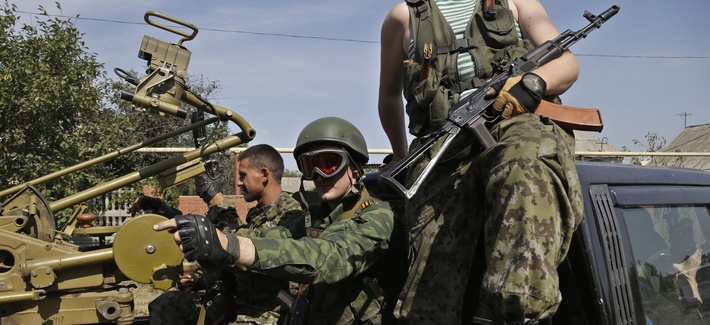 Pro-Russian fighters in Donetsk sit in a vehicle with a heavy machine gun attached, on September 7, 2014. 