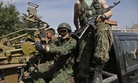 Pro-Russian fighters in Donetsk sit in a vehicle with a heavy machine gun attached, on September 7, 2014. 