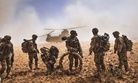 Soldiers with the 82nd Airborne Division gather their equipment before boarding a CH-47 Chinook in Nawa Valley, Kandahar Province, Afghanistan.