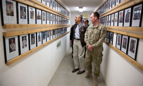 President Barack Obama and Brig. Gen. Erik Kurilla view photos of fallen military personnel at Bagram Airfield, Afghanistan, Sunday, May 25, 2014.