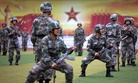 Chinese People's Liberation Army cadets shout as they take part in bayonet drills at the Armored Forces Engineering Academy Base, outside of Beijing, China. 
