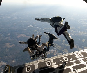 U.S. Navy SEALs exit a C-130 Hercules aircraft during a training exercise near Fort Pickett, Va. U.S. Navy SEALs exit a C-130 Hercules aircraft during a training exercise near Fort Pickett, Va.