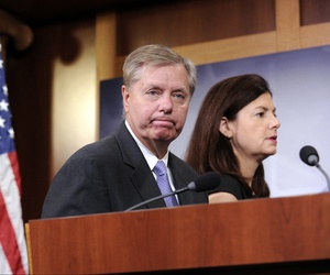 Sen. Lindsey Graham, R-S.C., and Sen. Kelly Ayotte, R-N.H., walks off the stage following a news conference on Capitol Hill, on July 24, 2014.