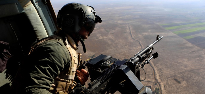 An Iraqi soldier secures an area from an helicopter carrying Iraqi Defense Minister Khalid al-Obeidi. 