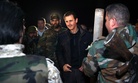 Syrian President Bashar al Assad speaks with troops on the front lines in Damascus, Syria, on January 1, 2015.