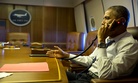 President Barack Obama talks on the phone with French President Francois Hollande from aboard Air Force One, on January 7, 2015.