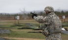 A specialist with the 533rd Brigade Support Battalion competes in a 9mm pistol course at the Best Warrior Competition at Fort McCoy, Wisc., on April 29, 2014.