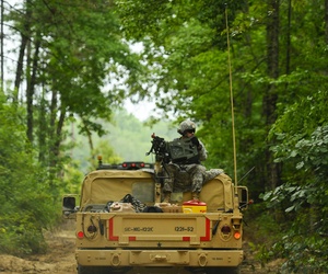 A soldier, assigned to 1221st Route Clearance Company, South Carolina Army National Guard, gunner on top a HMMVV scans for threats during route clearance operations at McCrady Training Center, Eastover, S.C., June 24, 2014. 