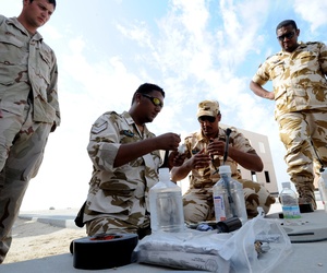An EOD technician observes Royal Bahrain Navy diverse and Royal Bahrain Army EOD as they assemble blasting devices during Neon Response 2012. An EOD technician observes Royal Bahrain Navy diverse and Royal Bahrain Army EOD as they assemble blasting devices during Neon Response 2012.