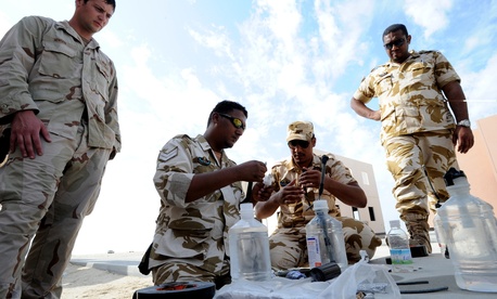 An EOD technician observes Royal Bahrain Navy diverse and Royal Bahrain Army EOD as they assemble blasting devices during Neon Response 2012. An EOD technician observes Royal Bahrain Navy diverse and Royal Bahrain Army EOD as they assemble blasting devices during Neon Response 2012.