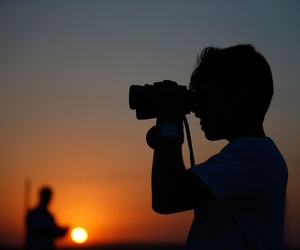 A youth uses binoculars to look at Turkish army tanks holding positions, near the border with Syria, in the outskirts of the village of Elbeyi, east of the town of Kilis, in southeastern Turkey, Thursday, July 23, 2015. A youth uses binoculars to look at Turkish army tanks holding positions, near the border with Syria, in the outskirts of the village of Elbeyi, east of the town of Kilis, in southeastern Turkey, Thursday, July 23, 2015.