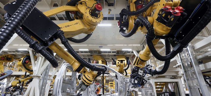 n this Nov. 11, 2014 file photo, robots install rivets on a 2015 Ford F-150 truck at the Dearborn Truck Plant in Dearborn, Mich.
