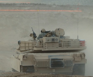Tracer fire whizzes by an Army Abrams tank during a Joint Forcible Entry Exercise on Aug. 5.