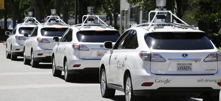 A row of Google self-driving cars parked in Mountain View, Calif., last year.
