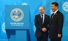Russian President Vladimir Putin, left, shakes hands with Chinese President Xi Jinping ahead of the Shanghai Cooperation Organization (SCO) summit in Ufa, Russia, Friday, July 10, 2015.