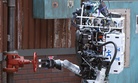 Robot Running Man from the Florida Institute for Human and Machine Cognition proceeds to turn a valve in the U.S. Defense Advanced Research Projects Agency Robotics Challenge in Pomona, Calif.