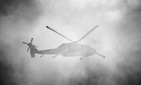 A United States Army Sikorsky UH-60 Blackhawk flies behind a cloud of smoke during the Combined Arms Demonstration at the Rhode Island National Guard Open House and Airshow, held at Quonset State Airport (KOQU/OQU) in North Kingstown, RI.
