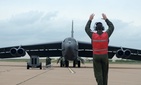 A U.S. Air Force airman marshals a B-52H Stratofortress bomber.
