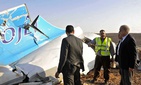 Egyptian Prime Minister Sherif Ismail, right, looks at the remains of a crashed Russian passenger jet in Hassana, Egypt.