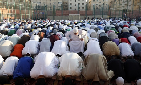 In this Friday, July 17, 2015 photo, worshippers attend the Eid al-Fitr prayers in an open field in Amman, Jordan. In this Friday, July 17, 2015 photo, worshippers attend the Eid al-Fitr prayers in an open field in Amman, Jordan.