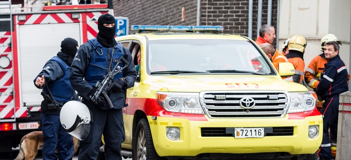 Armed police guard a street in Brussels on Monday, Nov. 16, 2015.