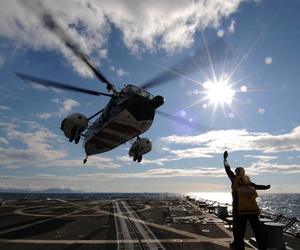 ATLANTIC OCEAN (April 23, 2012) Seaman Apprentice Pedro Deleon, front, communicates to the pilots of a Royal British navy helicopter using hand signals as they take off from the flight deck aboard the guided-missile destroyer USS Forrest Sherman (DDG 98). ATLANTIC OCEAN (April 23, 2012) Seaman Apprentice Pedro Deleon, front, communicates to the pilots of a Royal British navy helicopter using hand signals as they take off from the flight deck aboard the guided-missile destroyer USS Forrest Sherman (DDG 98).