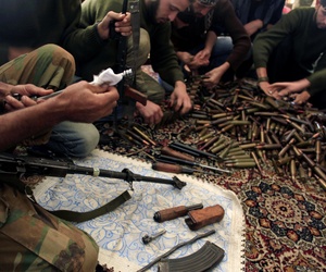 In this Wednesday, Nov. 14, 2012 file photo, Free Syrian Army fighters clean their weapons and check ammunition at their base on the outskirts of Aleppo, Syria.