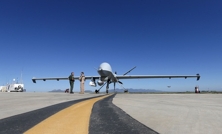 Lothar Eckardt, right, executive director of National Air Security Operations at U.S. Customs and Border Protection, speaks with a Customs and Border Patrol agent prior to a drone aircraft flight, Wednesday, Sept 24, 2014. Lothar Eckardt, right, executive director of National Air Security Operations at U.S. Customs and Border Protection, speaks with a Customs and Border Patrol agent prior to a drone aircraft flight, Wednesday, Sept 24, 2014.