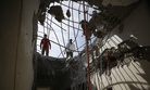 Men inspect a building damaged by a Saudi-led airstrike in Sanaa, Yemen, Tuesday, Jan. 5, 2016.