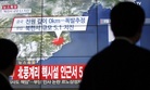People walk by a screen showing the news reporting about an earthquake near North Korea's nuclear facility, in Seoul, South Korea, Wednesday, Jan. 6, 2016.