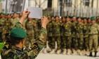 An Afghan National Army soldier holds up his diistinguished graduate certificate during the 3rd term graduation oath ceremony at Ghazi Military Training Center in Kabul, Afghanistan.