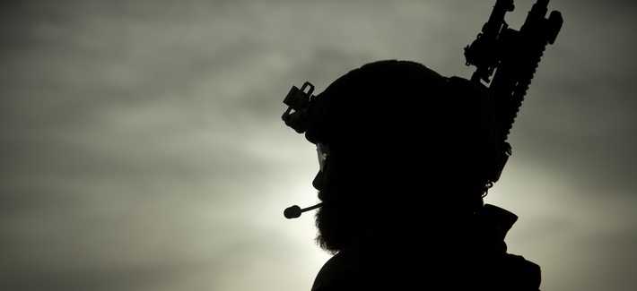 A U.S. Marine special operator assists with security during a construction project for an Afghan Local Police (ALP) checkpoint in Helmand province, Afghanistan, March 30, 2013. 