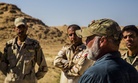 Iraqi Soldiers listen to a civilian contractor attached to Task Force Al Asad, talk about counter-improvised explosive device aboard Al Asad Air Base, Iraq, April 2, 2015.