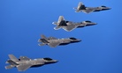 F-22 Raptors from the 94th Fighter Squadron and F-35A Lightning IIs fly in formation after completing a training mission.