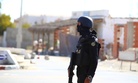 Tunisian police officers take positions as they search for attackers still at large in the outskirts of Ben Guerdane, southern Tunisia, Tuesday, Match 8, 2016.