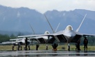 Lockheed Martin F-22 Raptors line up on a runway in 2006.