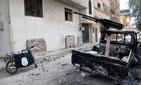 In this photo released on Sunday March 27, 2016, by the Syrian official news agency SANA, a burned vehicle with machine gun is seen next to a motorcycle draped with the Islamic State group flag, in the ancient city of Palmyra, central Syria. In this photo released on Sunday March 27, 2016, by the Syrian official news agency SANA, a burned vehicle with machine gun is seen next to a motorcycle draped with the Islamic State group flag, in the ancient city of Palmyra, central Syria.