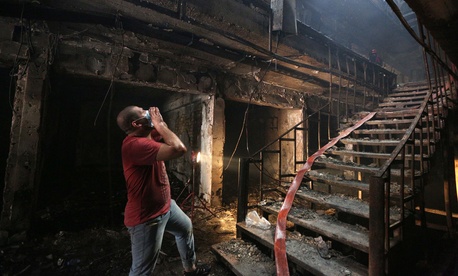 In this Sunday July 3, 2016, file photo, an Iraqi man looks for victims at the site of a deadly truck bomb attack in a commercial area of the Karada neighborhood, Baghdad, Iraq. In this Sunday July 3, 2016, file photo, an Iraqi man looks for victims at the site of a deadly truck bomb attack in a commercial area of the Karada neighborhood, Baghdad, Iraq.