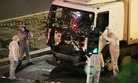 Authorities investigate a truck after it plowed through Bastille Day revelers in the French resort city of Nice, France, Thursday, July 14, 2016. 
