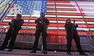 In this Nov. 14, 2015 file photo, heavily armed New York city police officers with the Strategic Response Group stand guard at the armed forces recruiting center in New York's Times Square. 