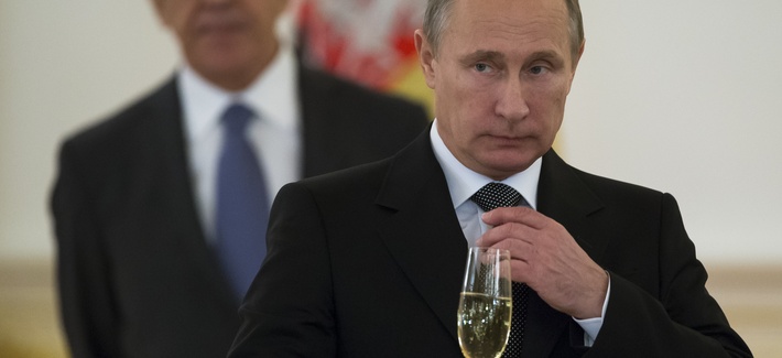 In a file photo from 2014, Russian President Vladimir Putin prepares to toast with ambassadors in the Grand Kremlin Palace in Moscow, Russia.