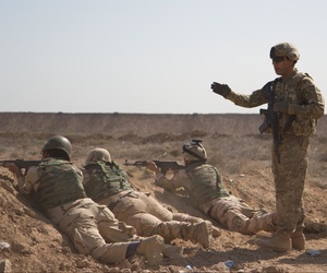 U.S. soldiers from the 82nd Airborne Division train Iraqi soldiers during a live-fire movement exercise at Camp Taji, Iraq, April 12, 2015.