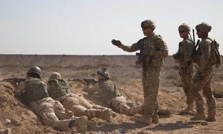 U.S. soldiers from the 82nd Airborne Division train Iraqi soldiers during a live-fire movement exercise at Camp Taji, Iraq, April 12, 2015.