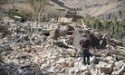 A man walks amid the rubble of a house destroyed by a Saudi-led airstrike on the outskirts of Sanaa, Yemen, Thursday, Feb. 2, 2017.