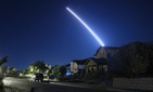 An operational test launch of an unarmed Minuteman III intercontinental ballistic missile from Vandenberg Air Force Base, Calif., is seen from nearby Lompoc, California in September 2013.